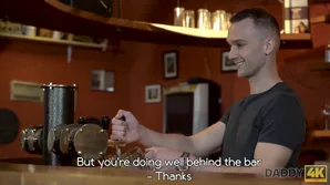 A handsome mature man indulges in a young girl on a table