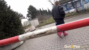 A natural redhead engages in a public water play act captured in high-quality video