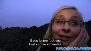 A blonde wearing glasses has sex outside in a first-person video